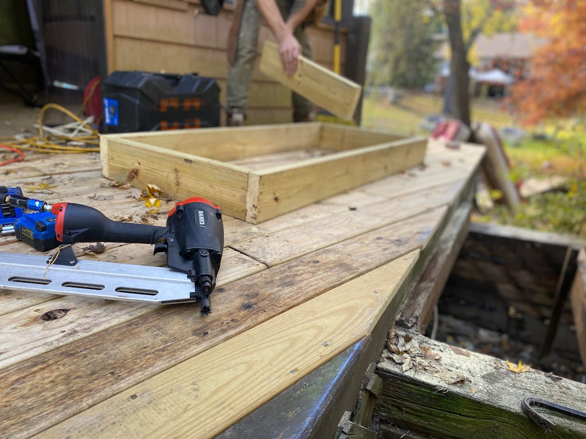 Deck framing under construction showing posts, beams, and joists before decking boards are installed — understanding the structure helps homeowners ask better questions and spot quality workmanship